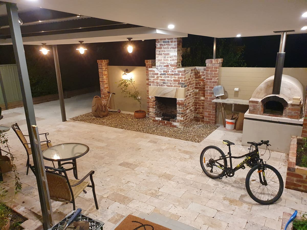 Outdoor room with brick fireplace and pizza oven