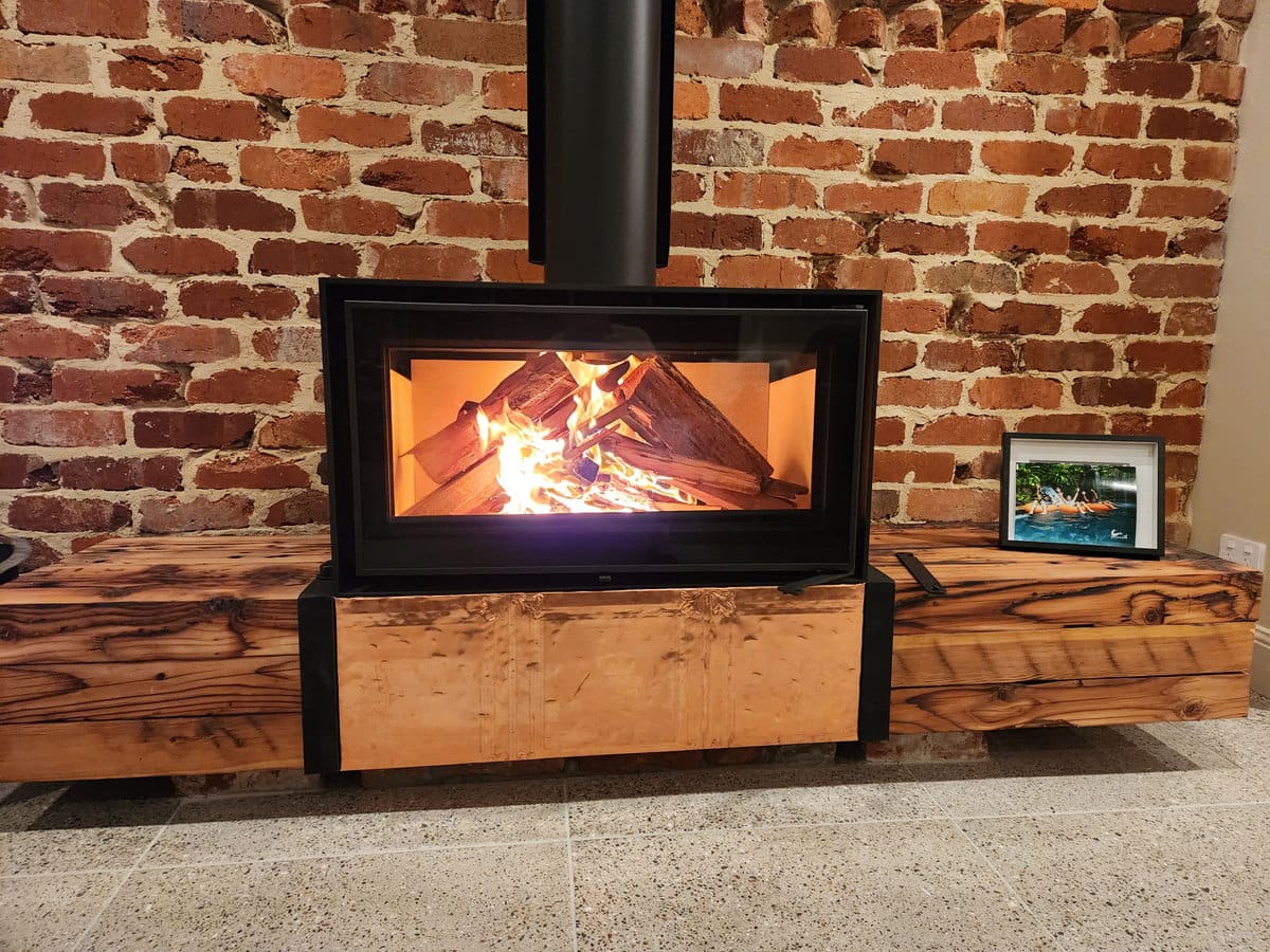 Fireplace hearth built from recycled timber and copper